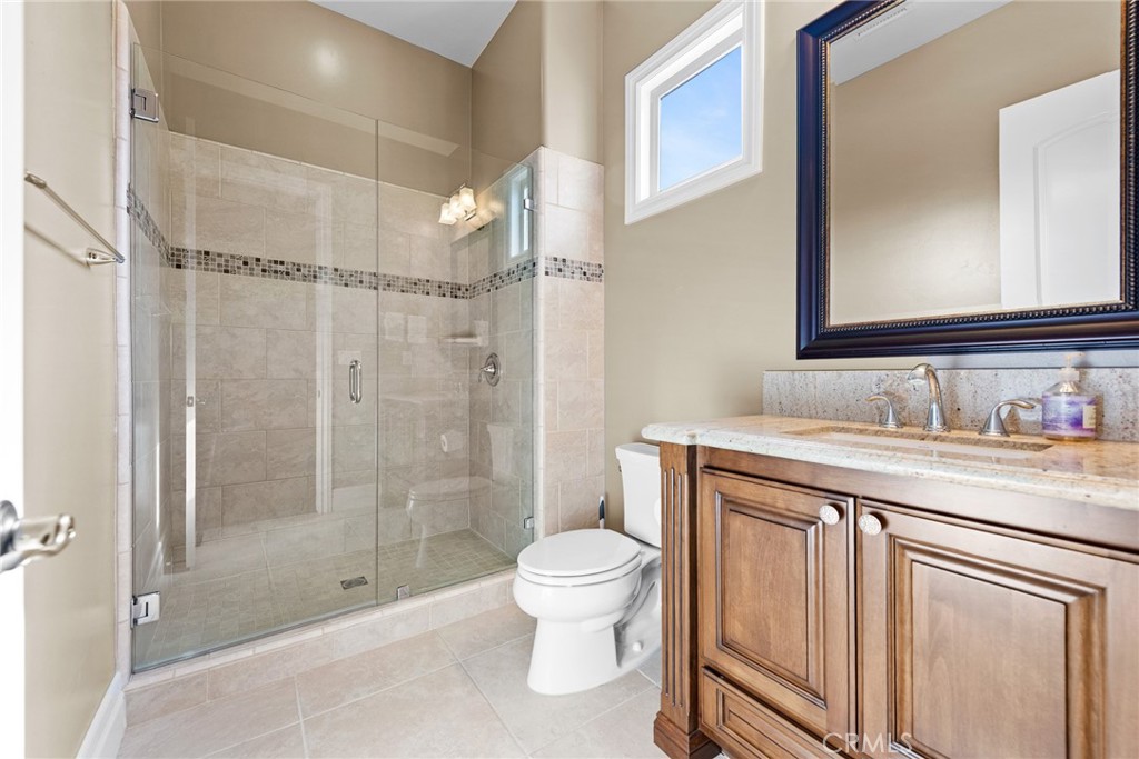 670 Pinnacle Ridge Road Riverside, CA 92506 - Photo 32 of 75 a bathroom with a granite countertop sink a toilet and shower