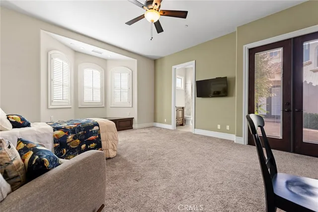 an empty room with closet and a ceiling fan