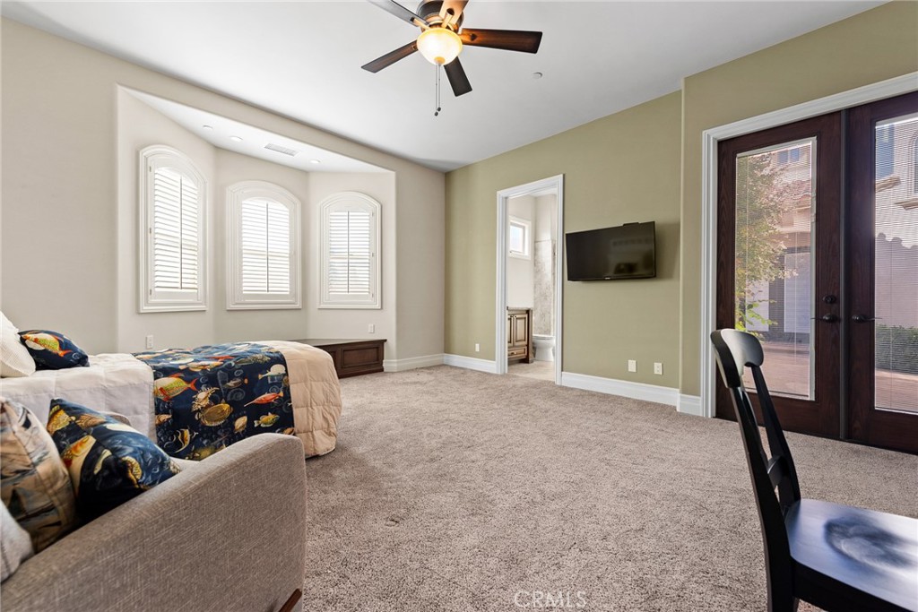 670 Pinnacle Ridge Road Riverside, CA 92506 - Photo 37 of 75 a bedroom with a bed and a chandelier