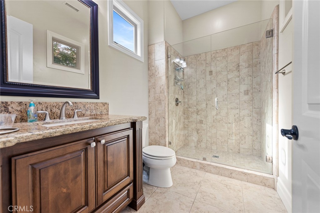 670 Pinnacle Ridge Road Riverside, CA 92506 - Photo 38 of 75 a bathroom with a granite countertop sink toilet and shower