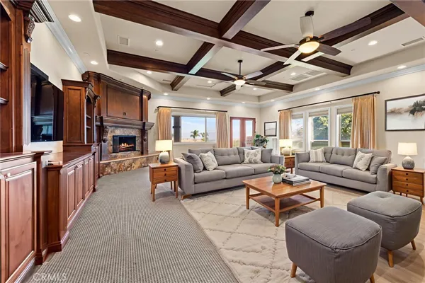 a living room with furniture kitchen view and a large window