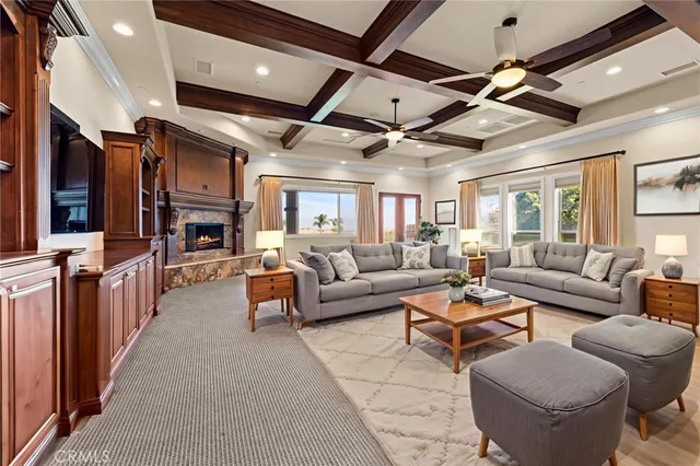a living room with furniture kitchen view and a large window
