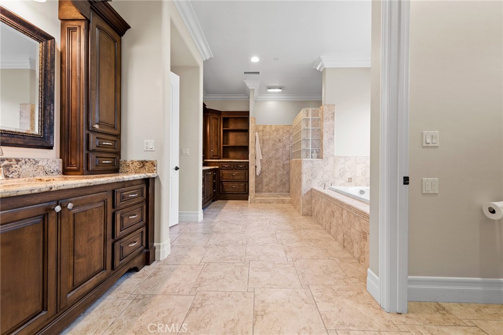670 Pinnacle Ridge Road Riverside, CA 92506 - Photo 41 of 75 a spacious bathroom with a granite countertop sink mirror and a