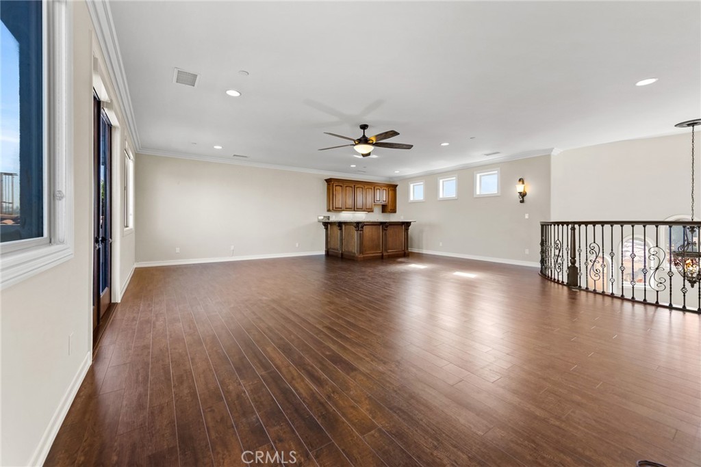 670 Pinnacle Ridge Road Riverside, CA 92506 - Photo 44 of 72 a view of a livingroom with wooden floor and a ceiling fan