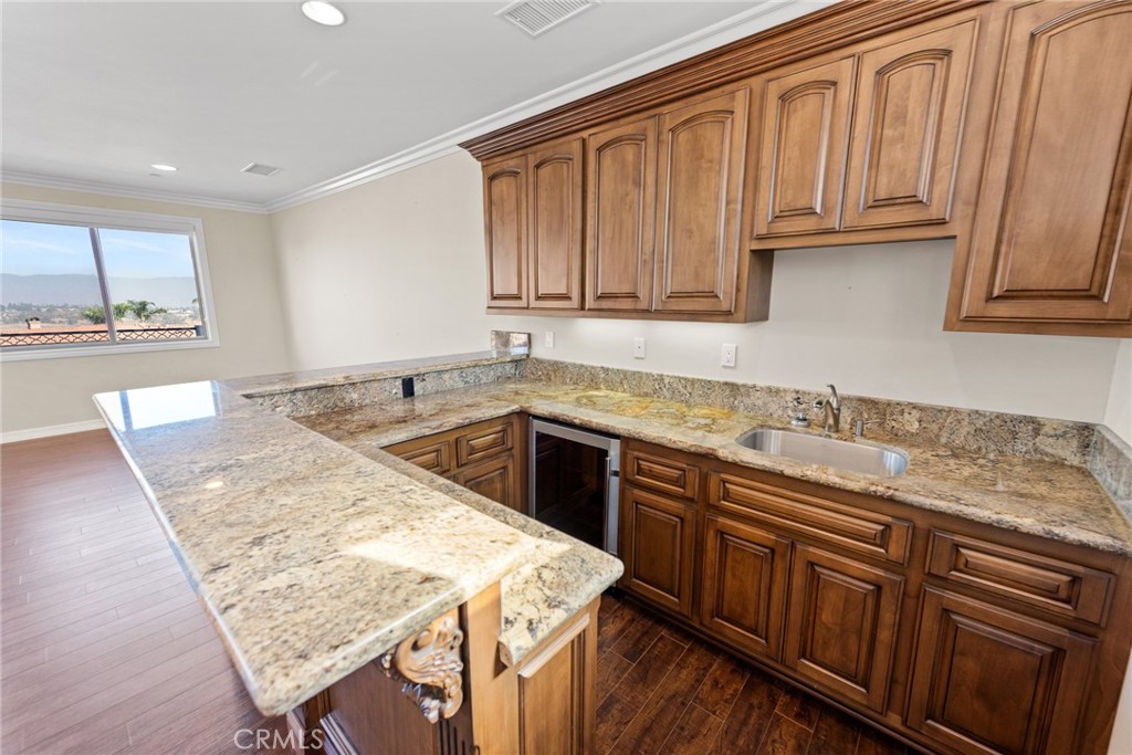 670 Pinnacle Ridge Road Riverside, CA 92506 - Photo 47 of 72 a kitchen with stainless steel appliances granite countertop wooden cabinets a sink and dishwasher