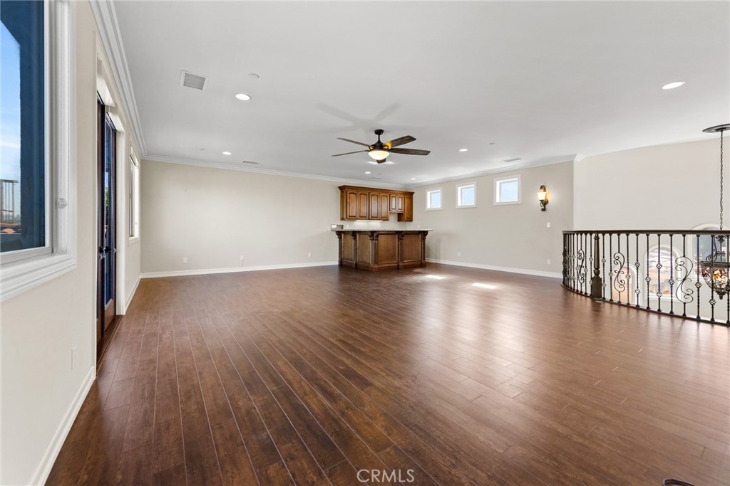 670 Pinnacle Ridge Road Riverside, CA 92506 - Photo 48 of 75 a view of a livingroom with wooden floor and a ceiling fan