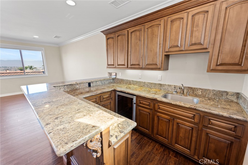 670 Pinnacle Ridge Road Riverside, CA 92506 - Photo 50 of 75 a kitchen with stainless steel appliances granite countertop wooden cabinets a sink and dishwasher