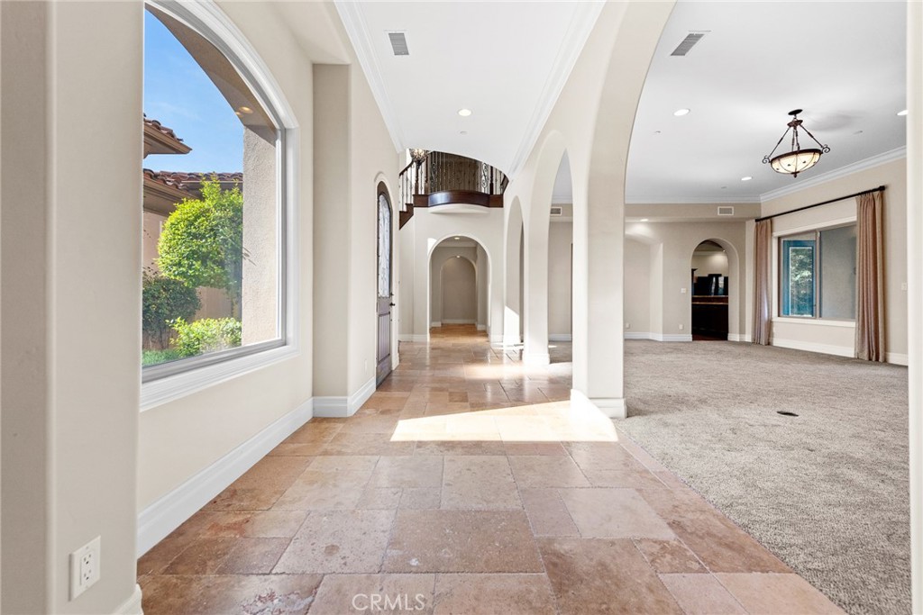 670 Pinnacle Ridge Road Riverside, CA 92506 - Photo 5 of 72 a view of a hallway with entryway windows and a chandelier