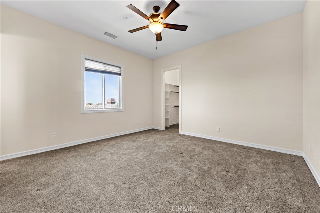 670 Pinnacle Ridge Road Riverside, CA 92506 - Photo 53 of 72 an empty room with closet and a ceiling fan