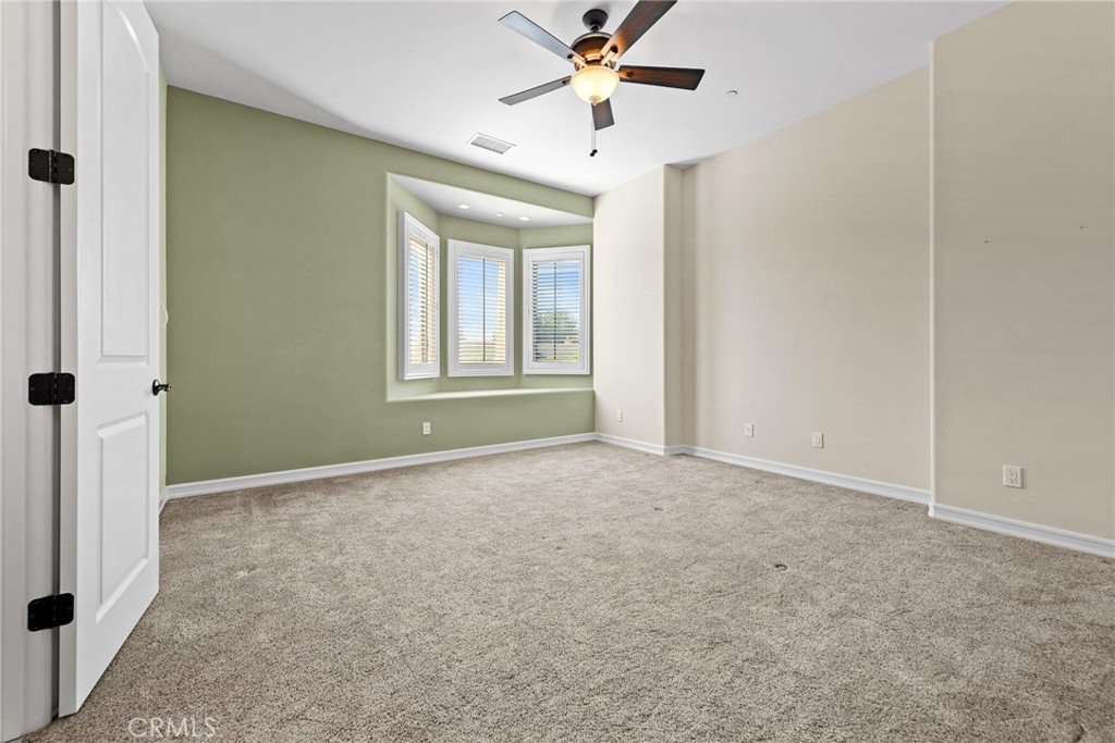 670 Pinnacle Ridge Road Riverside, CA 92506 - Photo 59 of 75 an empty room with windows and fan