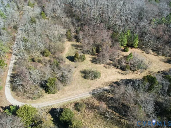 a view of a dry yard with trees