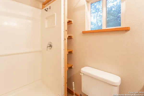 a white toilet sitting next to a bathroom sink