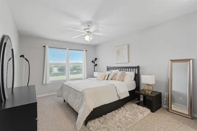 a bed room with a bed mirror and a window