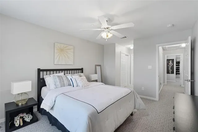 a bedroom with a large bed and a chandelier