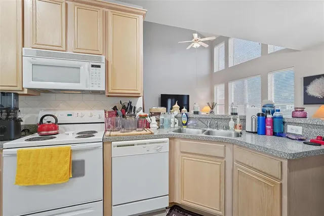 a kitchen with sink cabinets and appliances