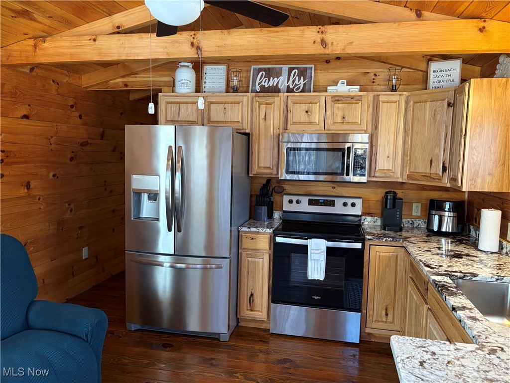 5919 Lake Road West, Unit 18 Ashtabula, OH 44004 - Photo 9 of 32 Kitchen featuring stainless steel appliances, wooden walls, light stone countertops, dark wood-type flooring, and a wooden ceiling with exposed beams