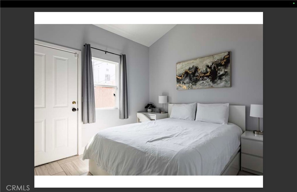 712 North Fuller Avenue West Hollywood, CA 90046 - Photo 12 of 23 a bedroom with a bed and a painting on the wall