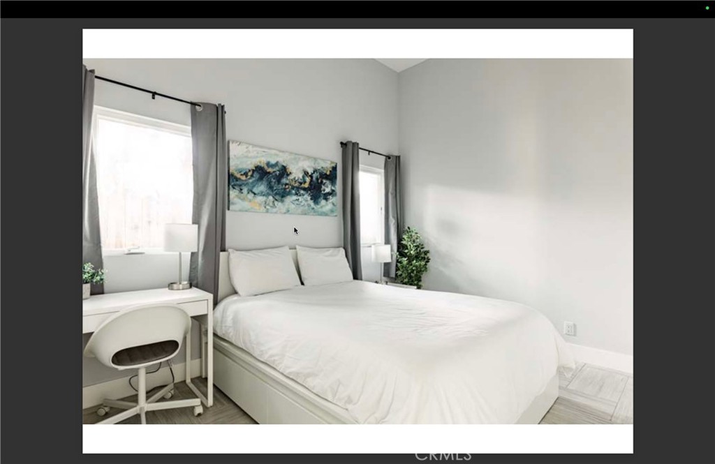 712 North Fuller Avenue West Hollywood, CA 90046 - Photo 13 of 23 a bedroom with a bed table and chair