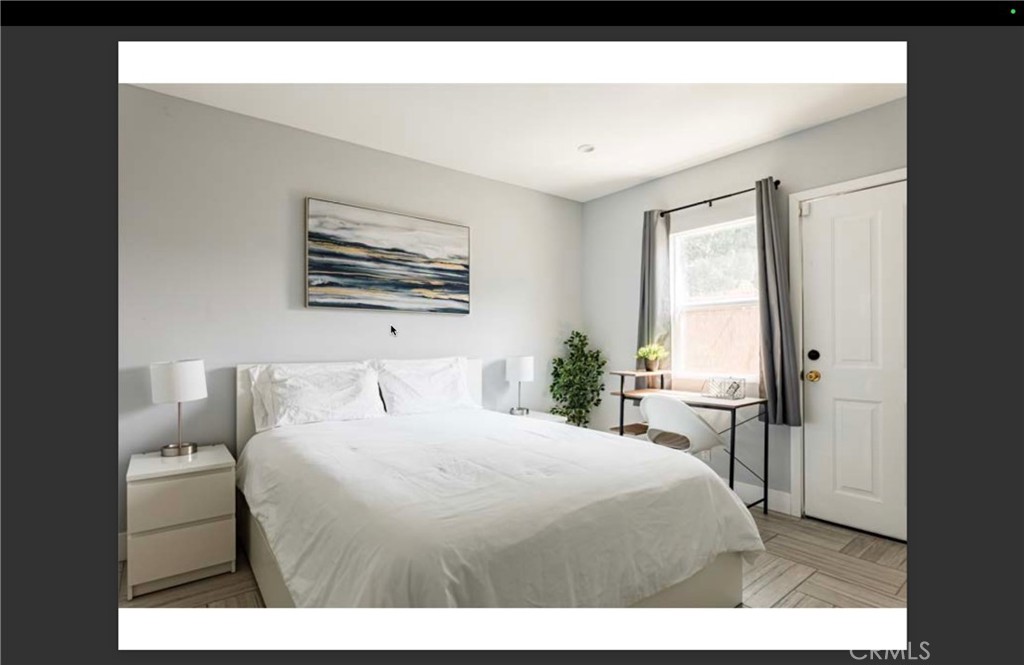 712 North Fuller Avenue West Hollywood, CA 90046 - Photo 14 of 23 a bedroom with a bed a mirror and a large window