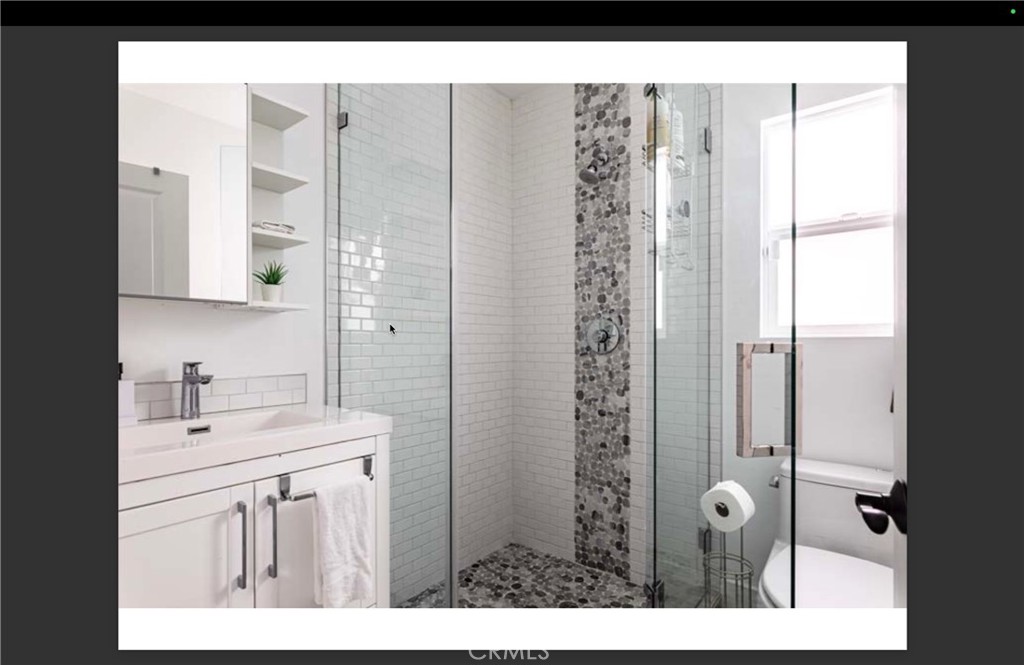 712 North Fuller Avenue West Hollywood, CA 90046 - Photo 15 of 23 a bathroom with a sink a mirror and shower