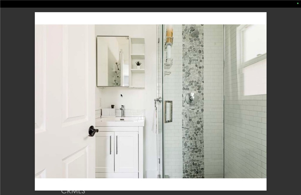712 North Fuller Avenue West Hollywood, CA 90046 - Photo 20 of 23 a bathroom with a sink a mirror and shower