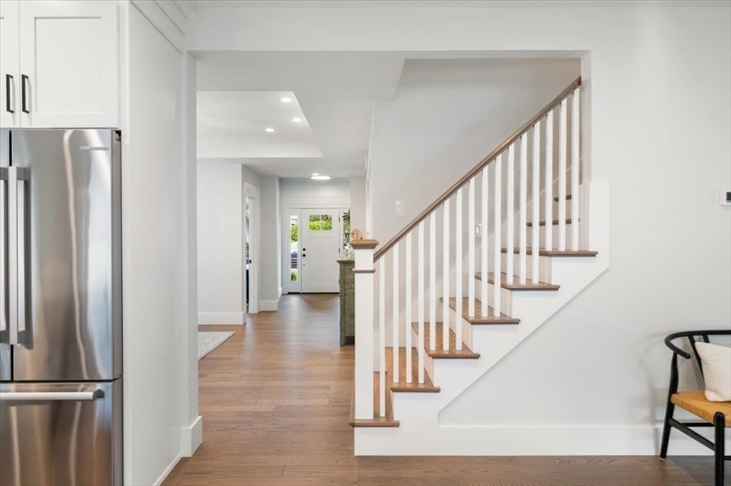18 Walcott Street Natick, MA 01760 - Photo 12 of 36 a view of staircase with lots of frames and a refrigerator