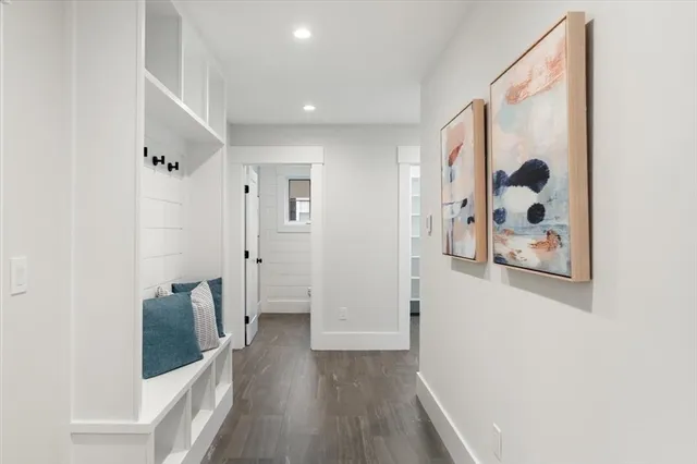 a view of a hallway with wooden floor and closet