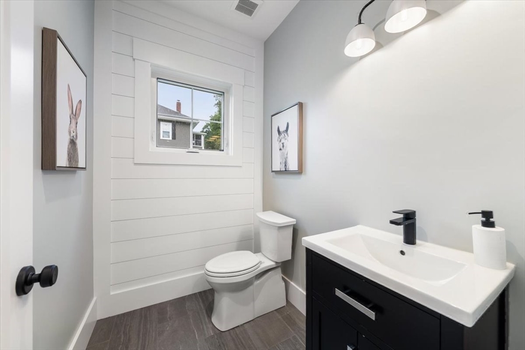 18 Walcott Street Natick, MA 01760 - Photo 24 of 36 a bathroom with a toilet sink and mirror