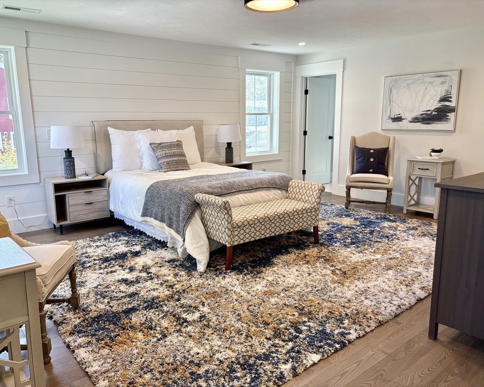 18 Walcott Street Natick, MA 01760 - Photo 25 of 36 a bedroom with a bed and wooden floor