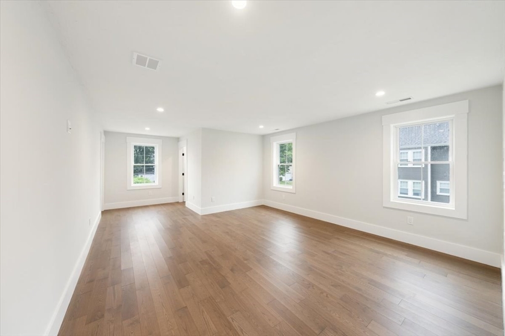 18 Walcott Street Natick, MA 01760 - Photo 29 of 36 an empty room with wooden floor and windows