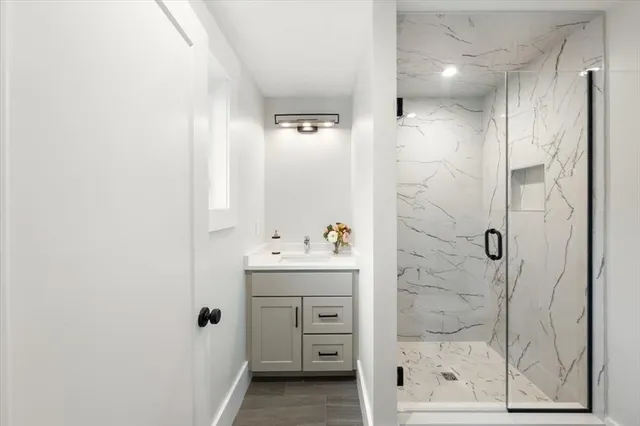 a bathroom with a shower and a sink
