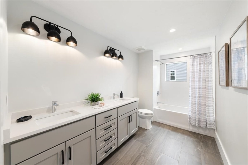 18 Walcott Street Natick, MA 01760 - Photo 32 of 36 a spacious bathroom with a double vanity sink a mirror and a shower