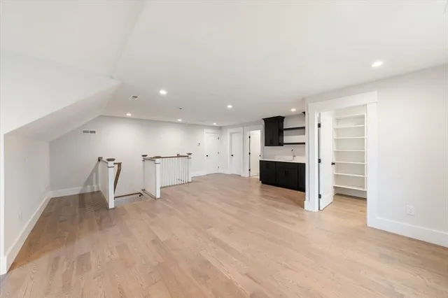a view of a kitchen with a sink and a refrigerator