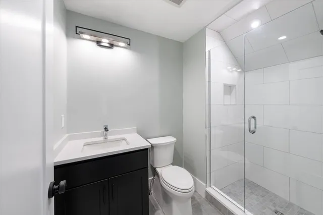 a bathroom with a sink toilet and shower