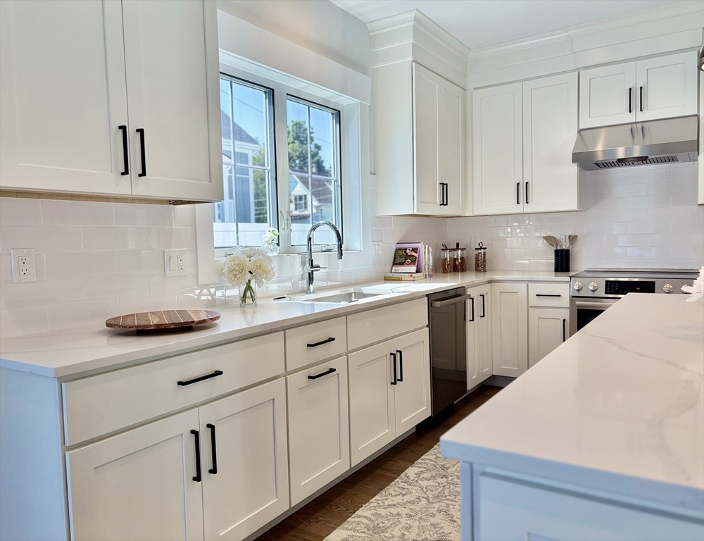 18 Walcott Street Natick, MA 01760 - Photo 9 of 36 a kitchen with cabinets stainless steel appliances a sink and a window