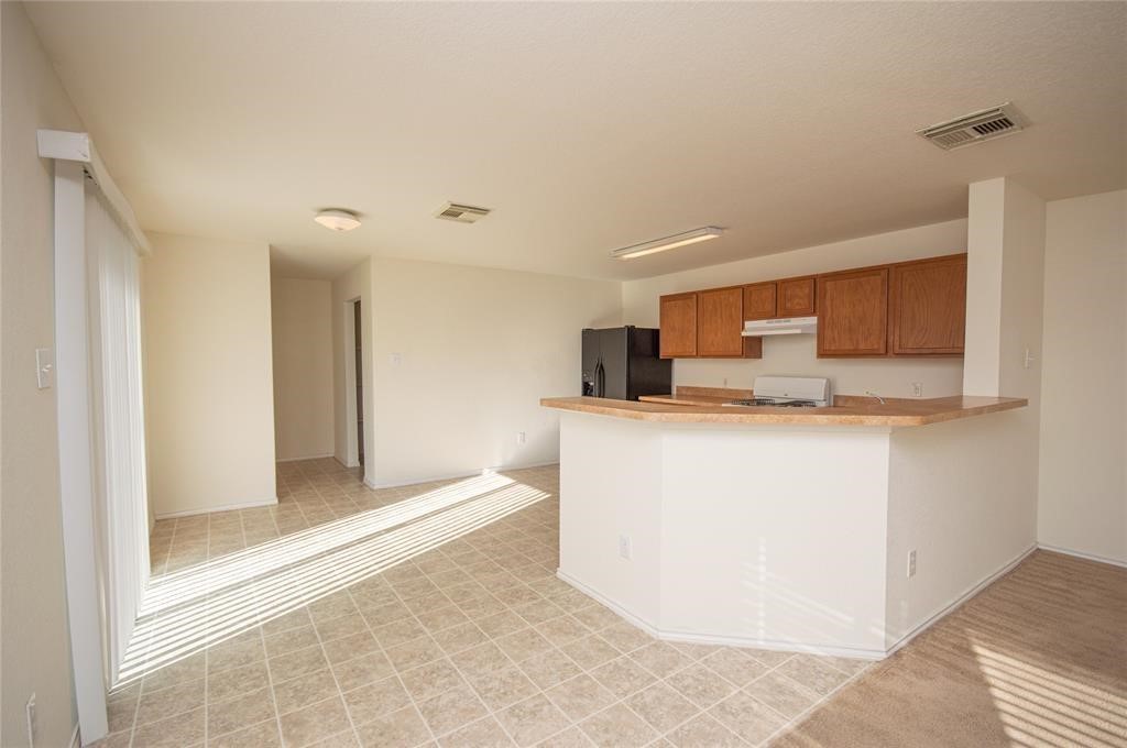 310 Falling Pine Drive Conroe, TX 77304 - Photo 5 of 15 a view of kitchen with refrigerator sink and microwave