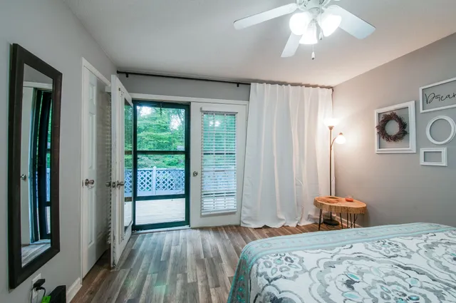 a bedroom with a large bed and a window