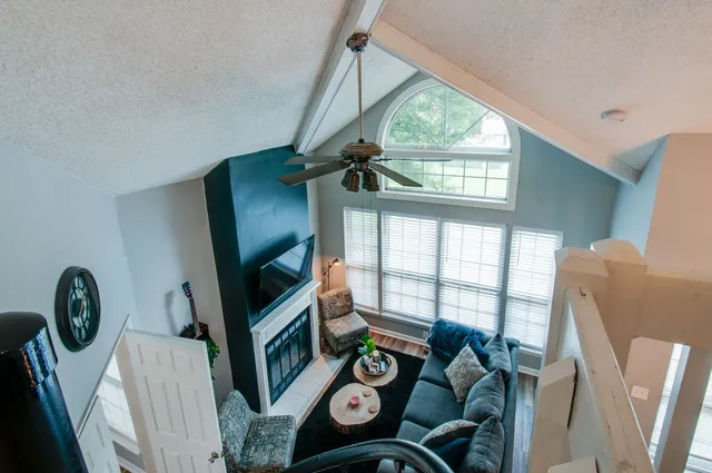 a bedroom with bed and a painting on the wall