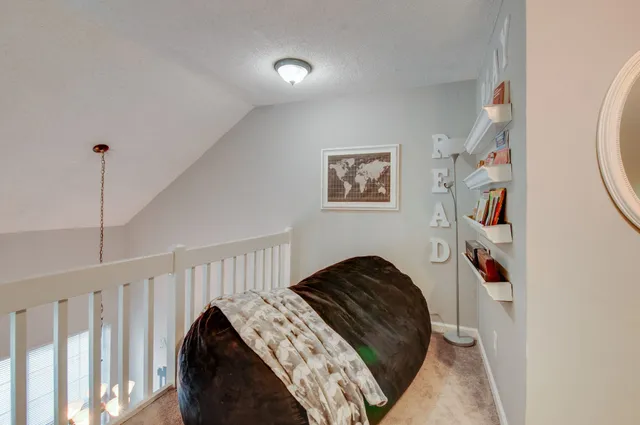 a bedroom with a bed and a mirror