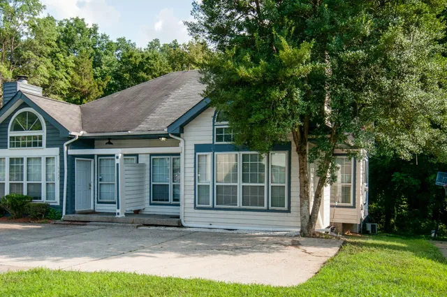 a house that has a tree in front of it