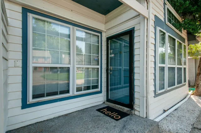 a living room with furniture a fireplace and a floor to ceiling window