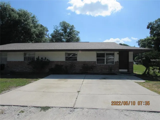 a view of house with yard