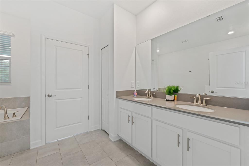 3000 Penelope Loop Kissimmee, FL 34746 - Photo 12 of 53 a bathroom with a granite countertop sink and a mirror