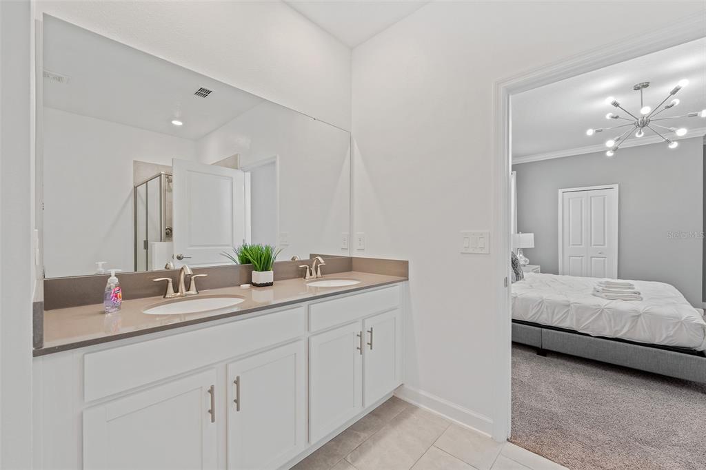 3000 Penelope Loop Kissimmee, FL 34746 - Photo 13 of 53 a en suite bathroom with double sink and a mirror
