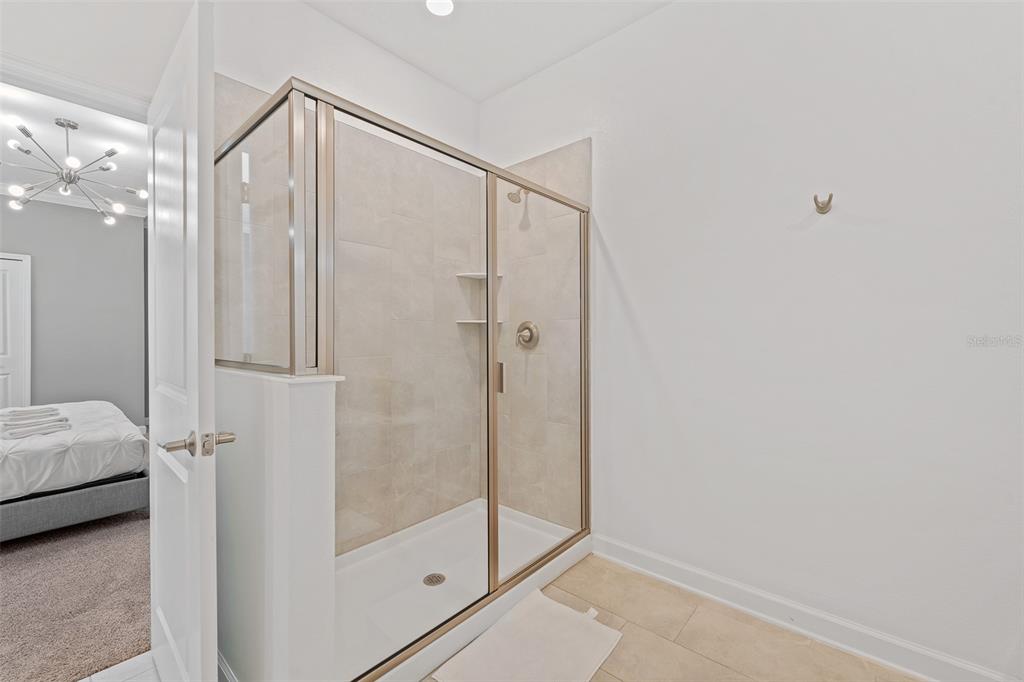 3000 Penelope Loop Kissimmee, FL 34746 - Photo 14 of 53 a bathroom with a glass shower door and a sink