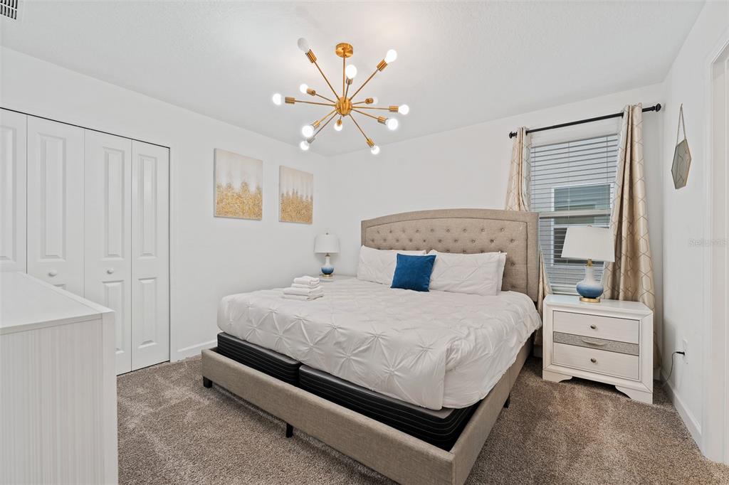 3000 Penelope Loop Kissimmee, FL 34746 - Photo 32 of 53 a bedroom with a bed and a chandelier