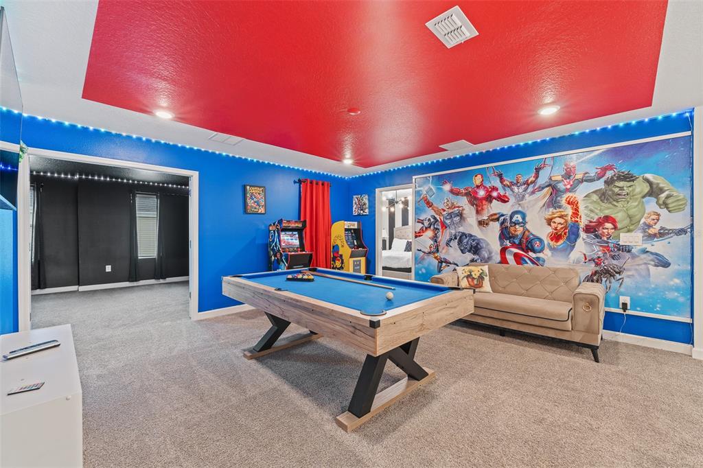 3000 Penelope Loop Kissimmee, FL 34746 - Photo 36 of 53 a living room with furniture a rug and a wall painting