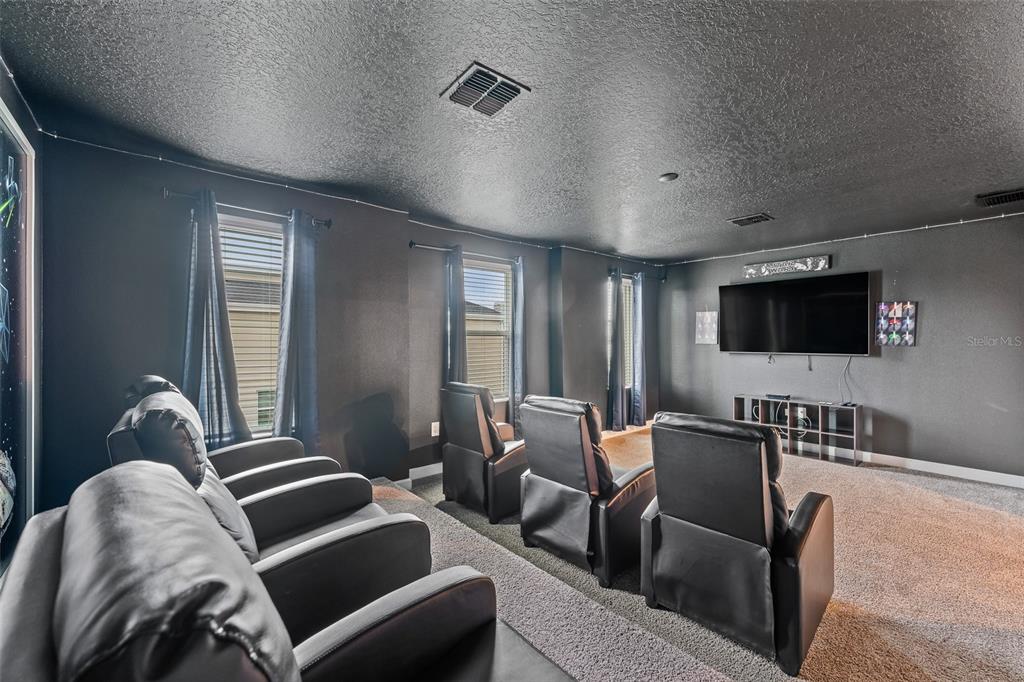 3000 Penelope Loop Kissimmee, FL 34746 - Photo 40 of 53 a living room with furniture and a flat screen tv