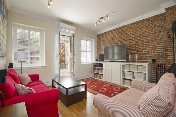 116 Charles Street, Unit 1 Boston, MA 02114 - Photo 1 of 8 a living room with furniture and a flat screen tv