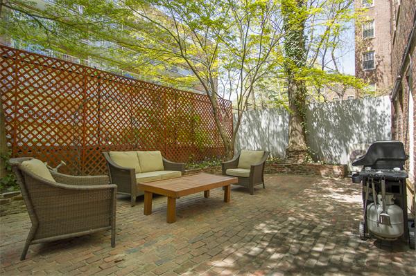 116 Charles Street, Unit 1 Boston, MA 02114 - Photo 3 of 8 a view of a bench in a backyard
